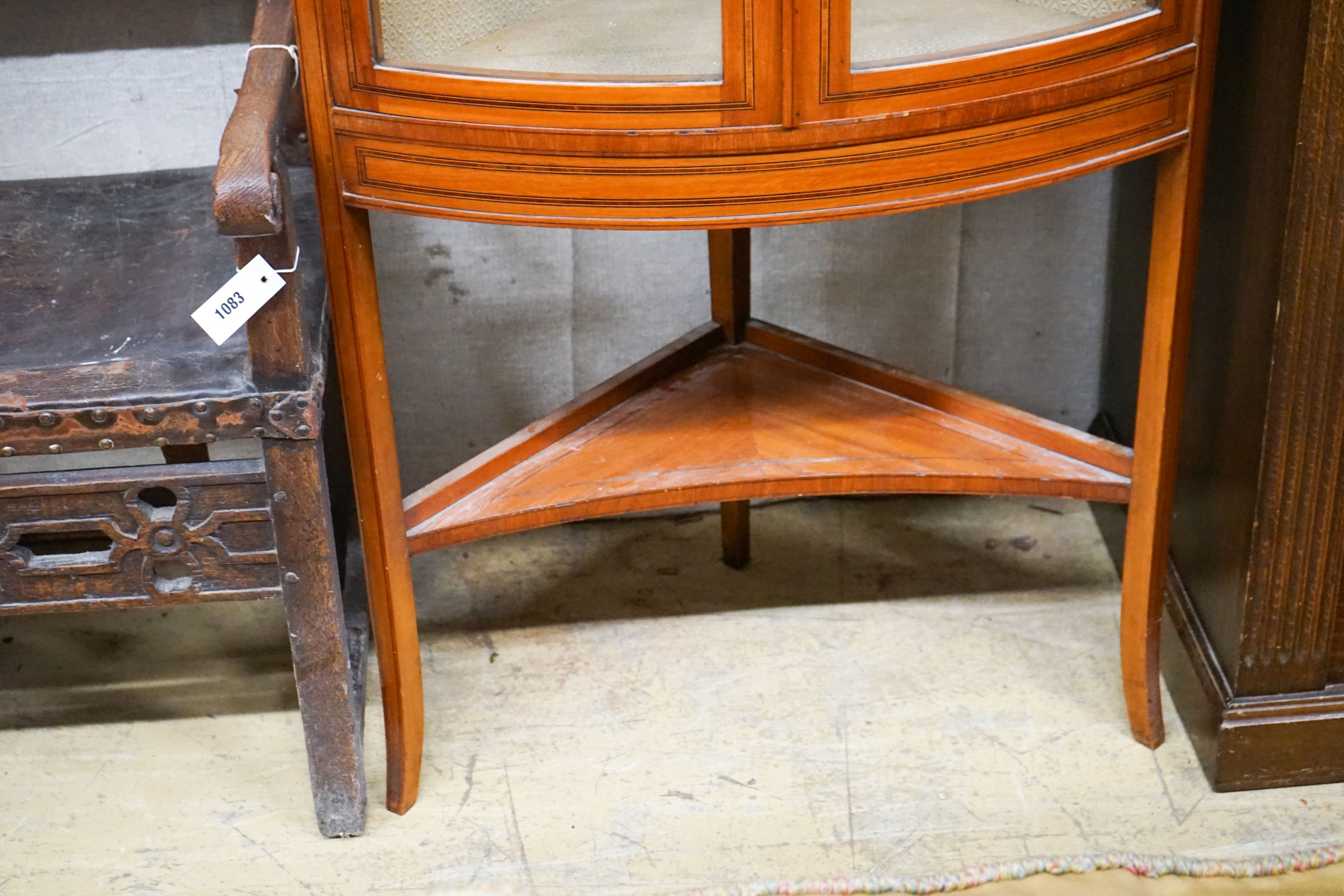 An Edwardian banded satinwood bowfront standing corner cabinet, width 76cm, depth 41cm, height 190cm